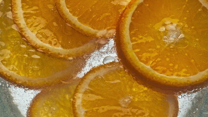 Fototapeta na wymiar Closeup oranges fizzy water in light background. Refreshing citrus beverage