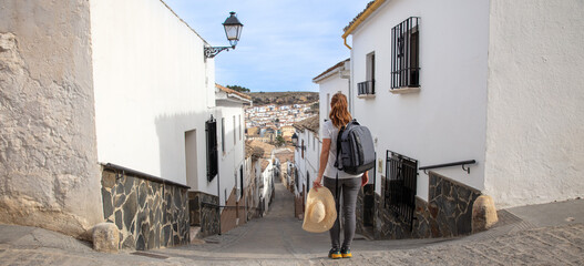 Woman tourist visiting typical street in Spain- Andalusia