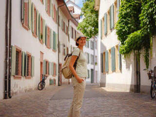 travel to summer Europe young asian woman. Woman having a great vacation in Switzerland, Basel. Lady visiting tourist attractions and landmarks.