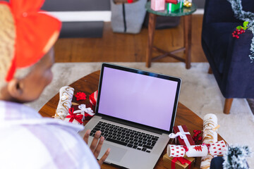 Happy african american woman using laptop with copy space