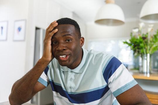 Happy African American Man Making Video Call Smiling To Camera Holding Head In Kitchen