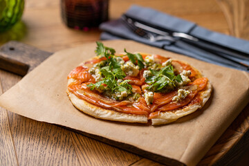 pizza with salmon on the table in the restaurant