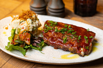 grilled pork ribs in sauce in a restaurant