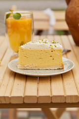 Healthy pumpkin slice of cake and natural sea buckthorn tea outside. Vegetarian recipe, delicious recipe