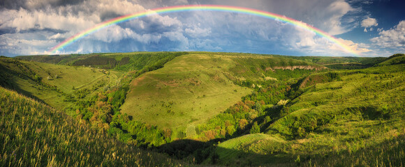 Beautiful landscape with a rainbow in the sky. spring landscape