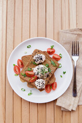 Fresh vegan sandwiches whole grain bread, tomatoes, herbs, quinoa and vegan sause.