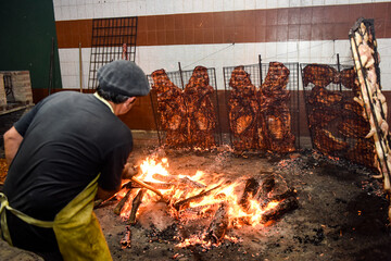 Gaucho grilling , barbecue, sausage and cow ribs, traditional argentine cuisine