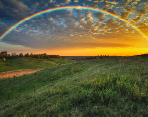 Rainbow over the meadow. picturesque spring morning. nature of Ukraine
