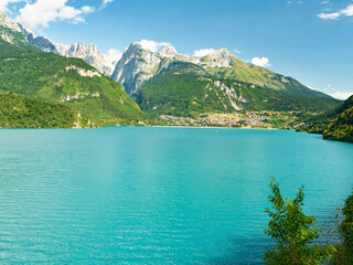 The town and lake with the same name Molveno lake nestled in the Dolomites