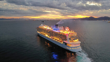 Aerial drone photo of huge illuminated cruise liner ship cruising to popular Aegean destinations at...