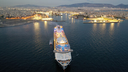Aerial drone photo of huge illuminated cruise liner ship cruising to popular Aegean destinations at...