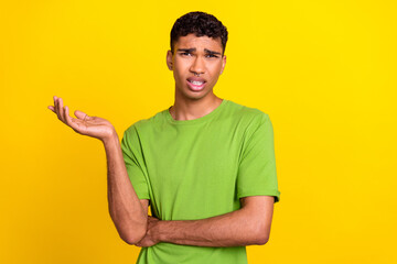 Photo portrait of nice young guy frowning argue dispute conflict disagree dressed trendy green outfit isolated on yellow color background