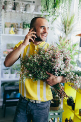 Man talking on mobile phone in florist shop