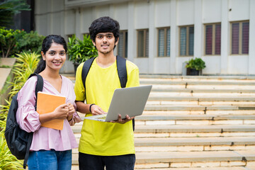 closeup shot of Happy smiling students with backpack holding laptop and smilling at camea at college campus - concept of technology, learning and skill development.