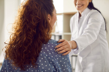 Doctor supporting her patient. Cropped shot of a happy, smiling nurse or doctor in white coat...