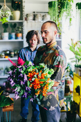 Two men work in florist shop.