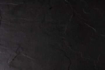 Natural black stone background, top view