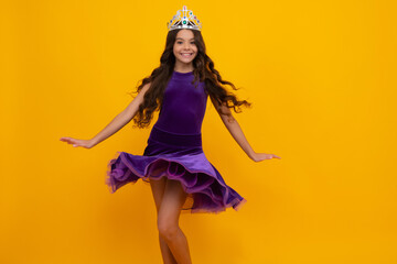 Movement windy dress. Girls party, funny kid in crown. Child queen wear diadem tiara. Cute little princess portrait. Happy girl face, positive and smiling emotions. © Olena