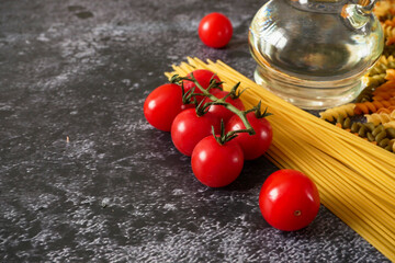 Various types of pasta, Raw pasta set and tomato, set.