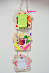 DIY  children's cardboard crafts - colored parrot on a white paper sheet. Scissors