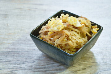 fried slice Chinese sweet pickled cabbage with egg on bowl