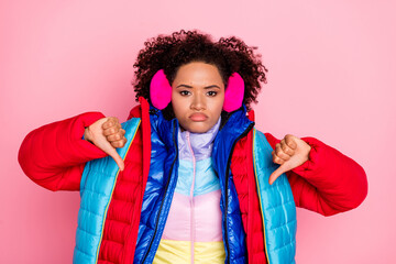 Photo of young lady show fingers thumb-down decline denial disagree wear many clothes isolated over pink color background