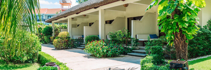 Fototapeta na wymiar Long panorama Exterior design luxury RESORT house apartment room garden tropical green palm landscape sun day