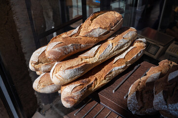 French bakery, many fresh baked baguettes breads ready for sale close up