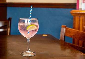 Glass of gin and tonic cocktail served in old vintage Scottisch pub, drinking gin in Edinburgh, UK