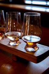 Flight of single malt scotch whisky in glasses served in whiskey bar in Edinburgh, UK