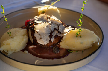 Beefsteak served with fresh black truffle mushroom and balls of mashed potato in French restaurant