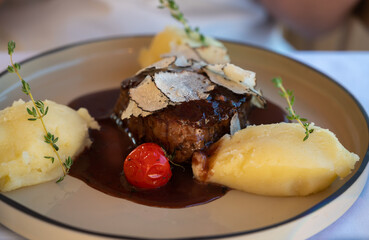 Beefsteak served with fresh black truffle mushroom and balls of mashed potato in French restaurant