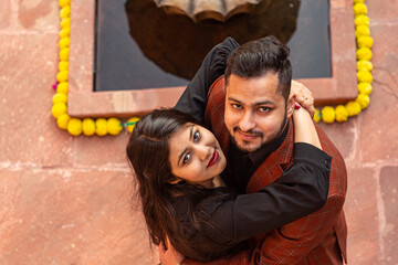A young Indian couple shooting their pre wedding at a heritage fort in Delhi India. Romantic couple having shoot Delhi. Best young couple India. Pre wedding Indian couple.