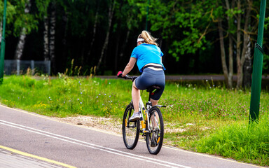 Cyclist ride on the bike path in the city Park
