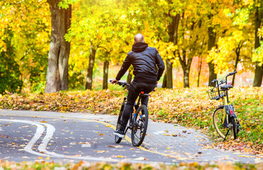 Fototapeta premium Cyclist ride on the bike path in the city Park 