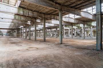 Fototapeta na wymiar Ruined industrial area, abandoned ruins of a plant or factory. Huge vacant lot. Background