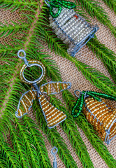 South African Beaded Christmas decorations with tree bits on rustic burlap fabric