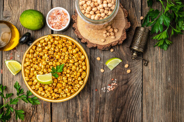 fried spicy chickpeas with lime on wooden table background. banner, menu, recipe place for text, top view