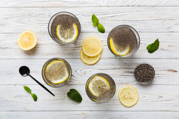 Healthy breakfast or morning with chia seeds lemon and mint on table background, vegetarian food,...