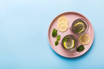 Healthy breakfast or morning with chia seeds lemon and mint on table background, vegetarian food, diet and health concept. Chia pudding with lemon and mint
