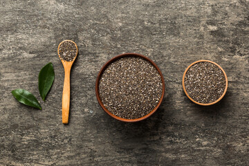 Chia seeds in bowl and spoon on colored background. Healthy Salvia hispanica in small bowl. Healthy superfood