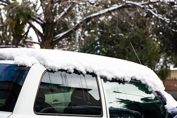 Fototapeta na wymiar Car under snow in winter after a heavy snowfall, January