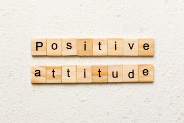 Positive Attitude word written on wood block. Positive Attitude text on cement table for your desing, concept