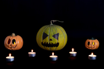Halloween pumpkins with candles in the darkness.
