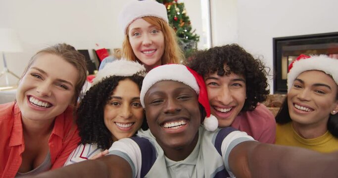 Happy group of diverse friends taking selfie and smiling