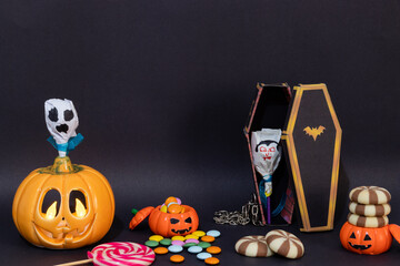 Trick or treat concept Halloween table on dark background.