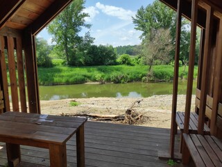 wooden bower near the river with beach © Jan