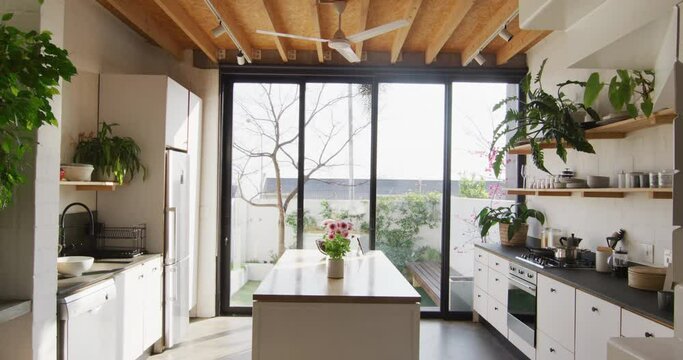 General view of modern kitchen with countertop, kitchen equipment and window
