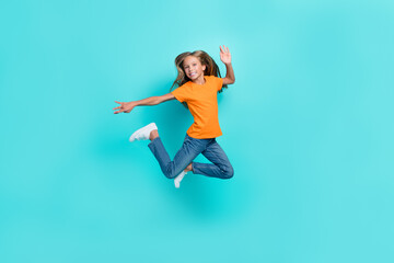 Fototapeta na wymiar Full body length photo of excited crazy pretty schoolkid girl jumping air trampoline carefree hand acitivity movement isolated on aquamarine color background