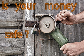 The burglar breaks open the door with an angle grinder. Concept - keep money in a safe bank.